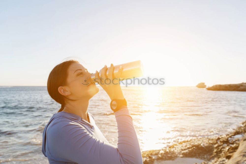 Similar – Fit sporty woman drinking water from a bottle