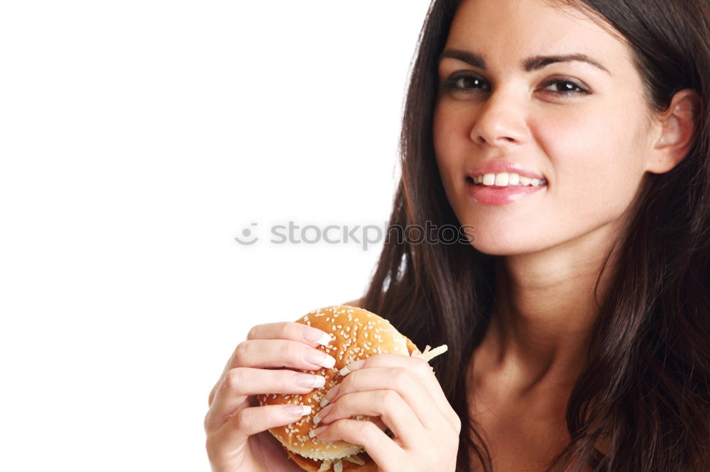 Similar – Woman taking bite of hamburger in restaurant