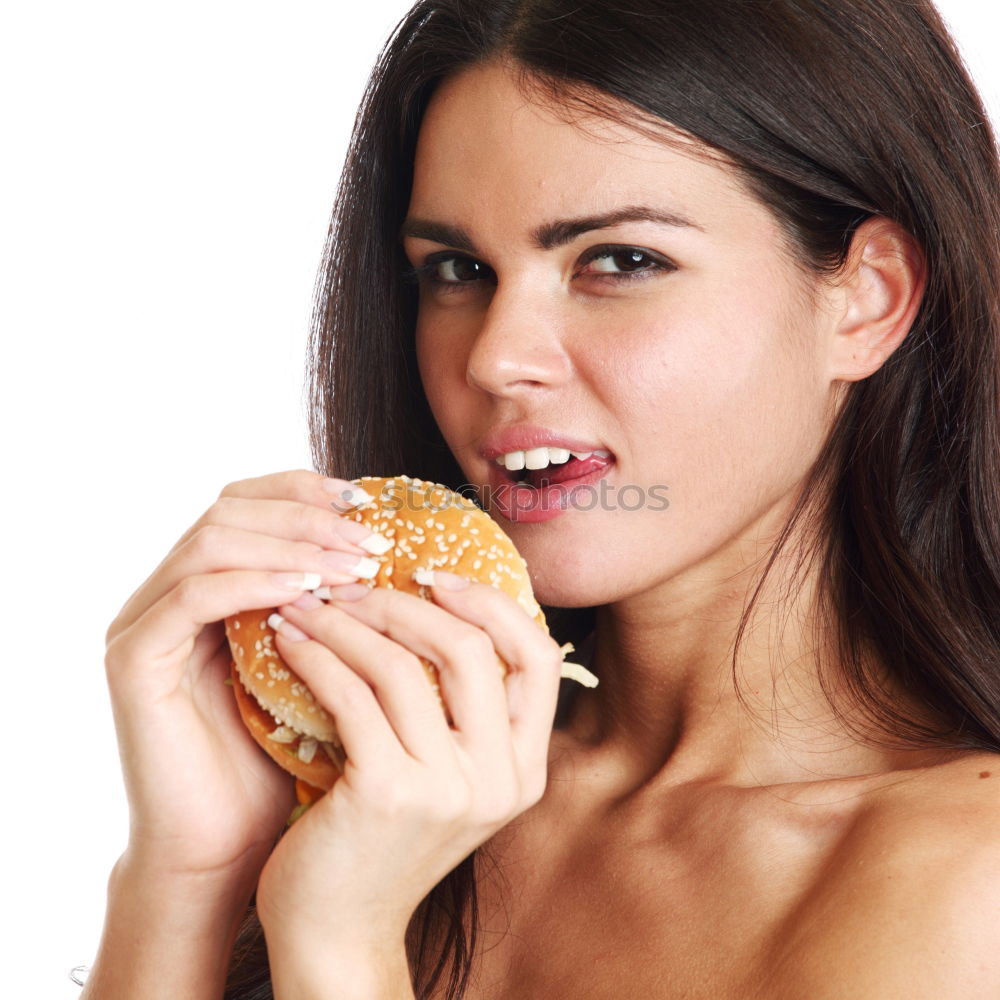 Similar – Woman taking bite of hamburger in restaurant