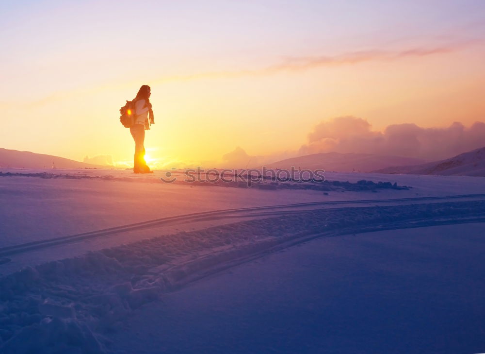 Woman walking outdoors on sunny snowy day in winter