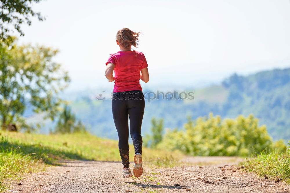 Similar – Cheerful woman running through field