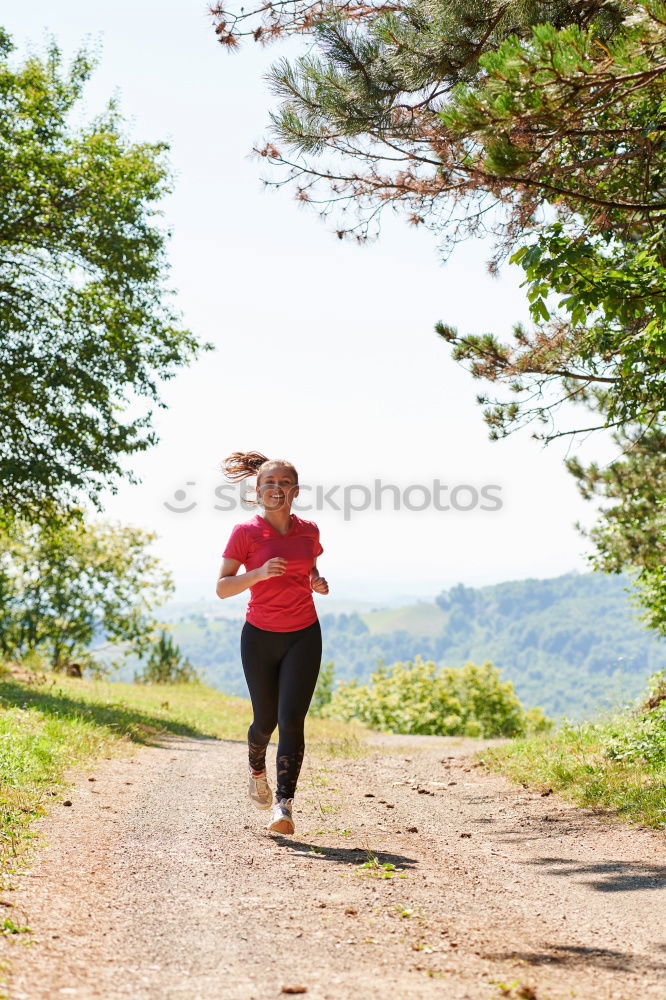Similar – Image, Stock Photo Athletic young woman jogging along a forest track