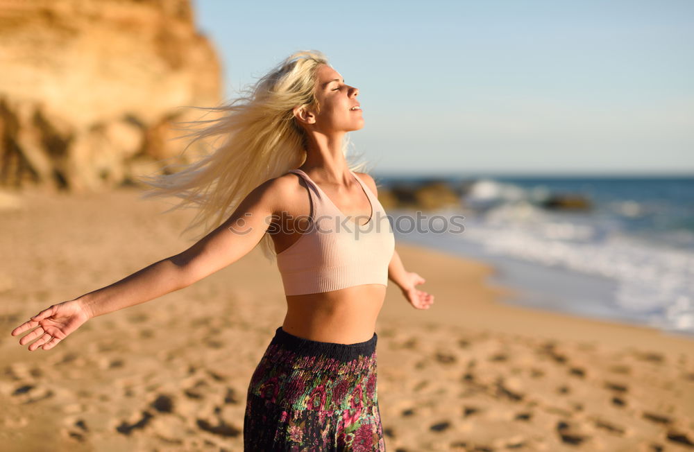 Similar – Woman enjoying the sunset on a beautiful beach