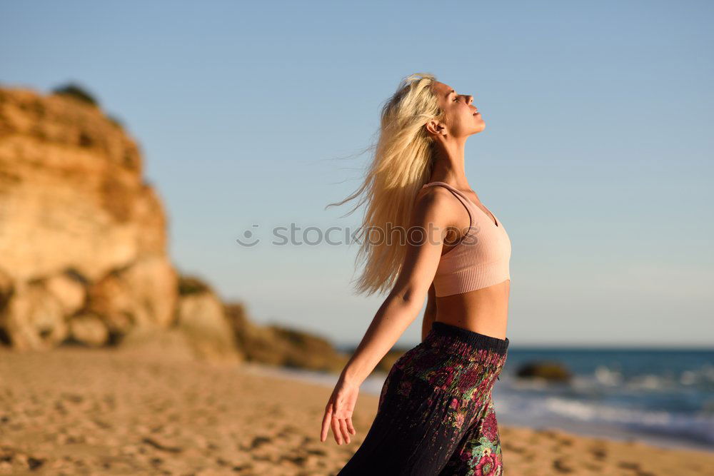 Similar – Woman enjoying the sunset on a beautiful beach