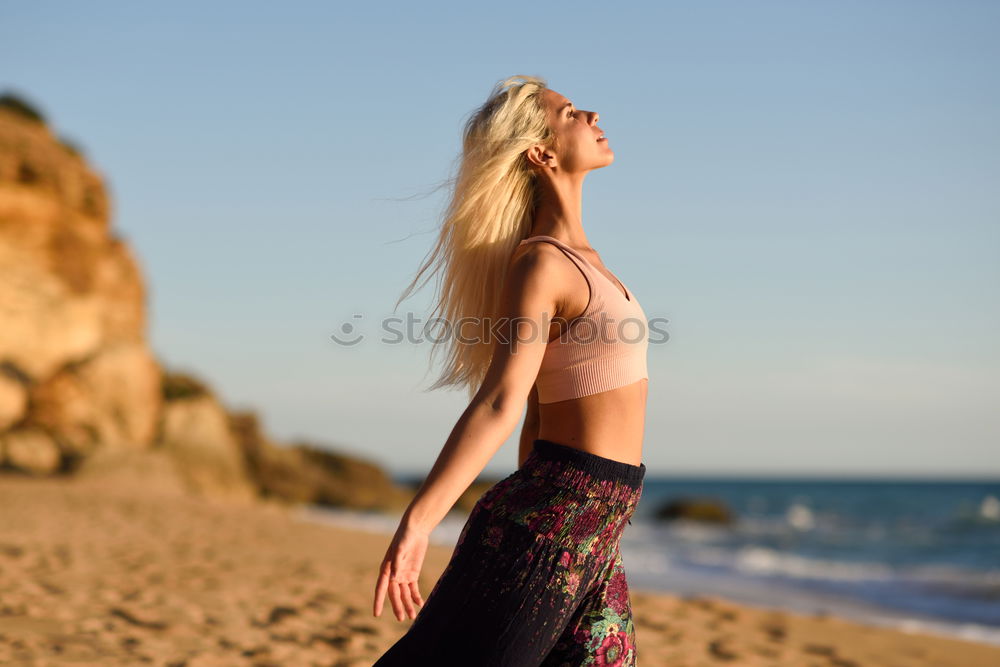 Similar – Woman enjoying the sunset on a beautiful beach