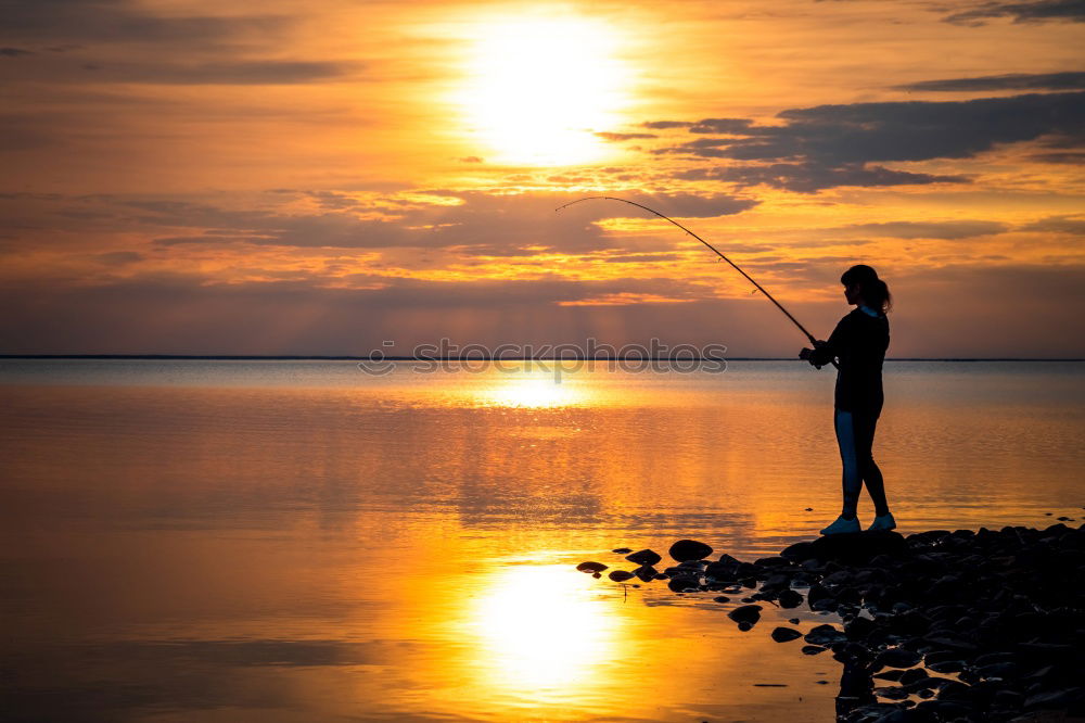 One happy little girl playing on the beach at the sunset time.