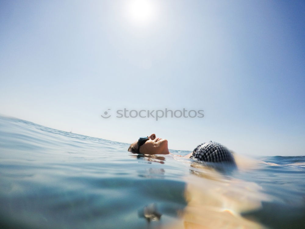 Image, Stock Photo Man in wetsuit swimming in ocean