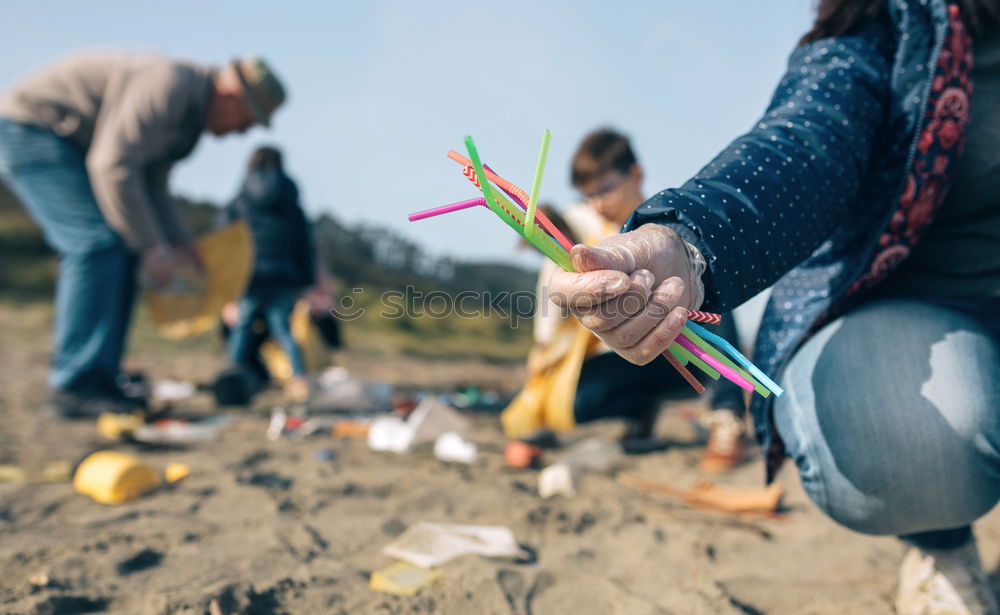 Similar – Young man cleaning the beach