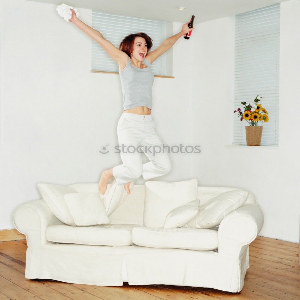 Similar – Long haired girl in jeans jumps headfirst into a sofa