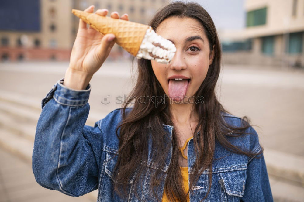 Similar – portrait of young woman eating bubble gum in brick background