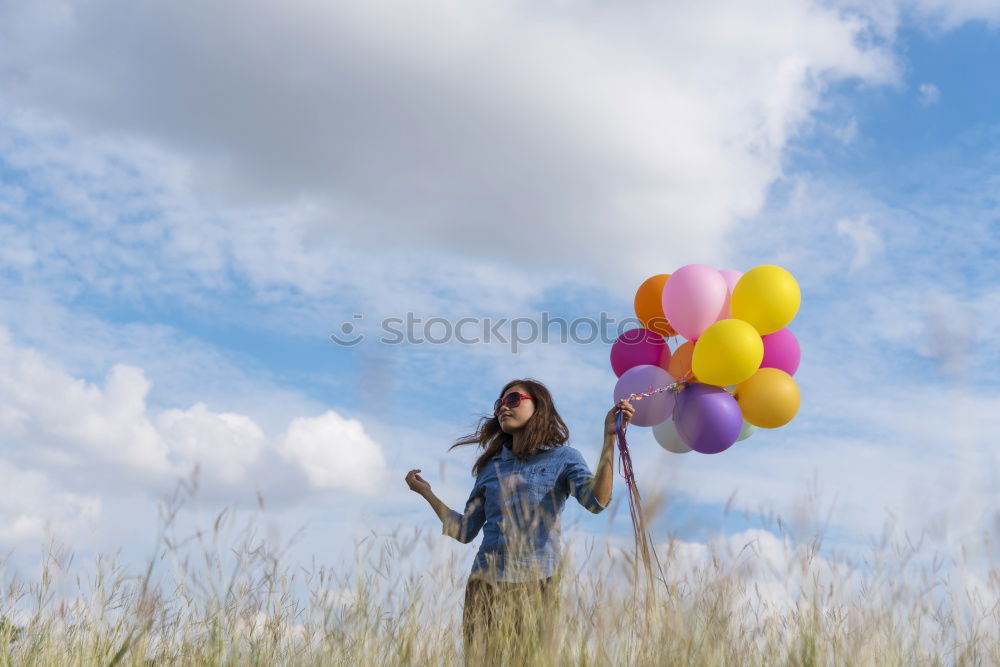 Similar – young woman with balloon on the mountain at a city