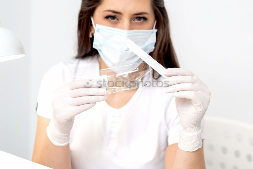 Similar – Image, Stock Photo Nurse with mouth guard examines laboratory sample