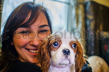 Similar – White smiling girl holing her dog in the arms