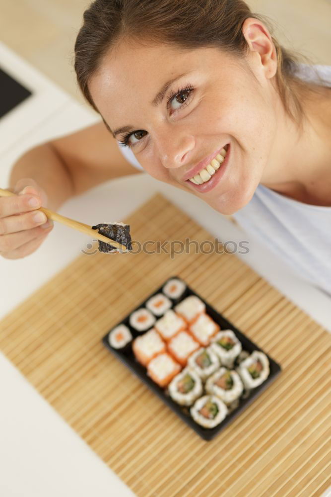 Similar – Woman chef hands rolling up japanese sushi