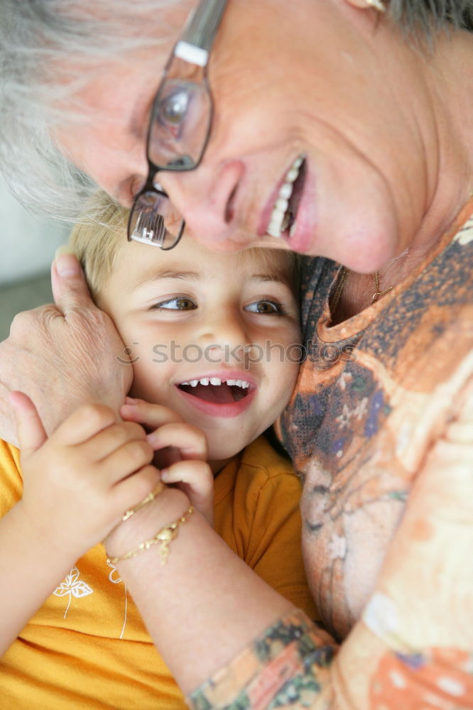 Similar – Adult woman holding a child eating a strawberry