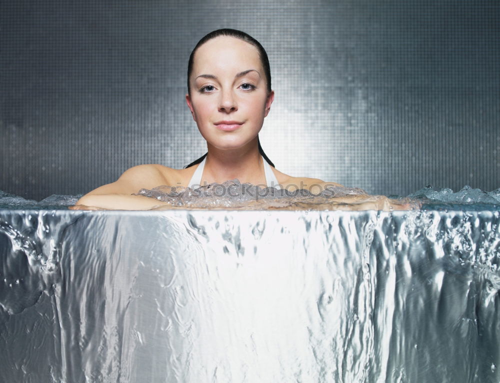 Playful mischievous woman with wet hair in a towel