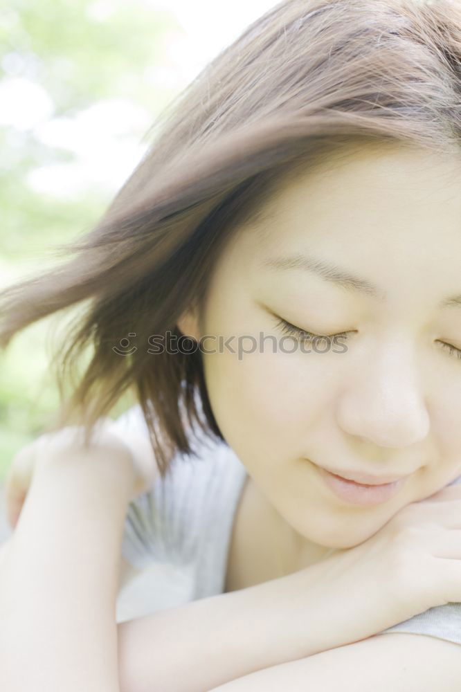 Similar – Portrait of a cute little girl with colored bracelets lying on her arm