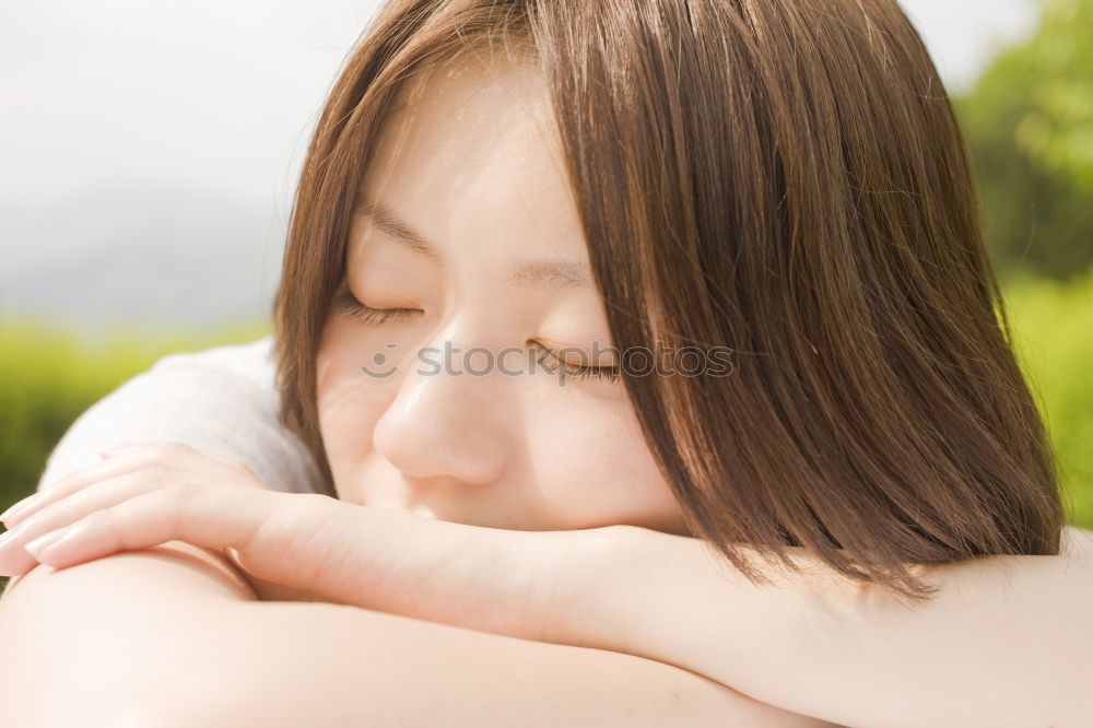 Similar – Portrait of a cute little girl with colored bracelets lying on her arm