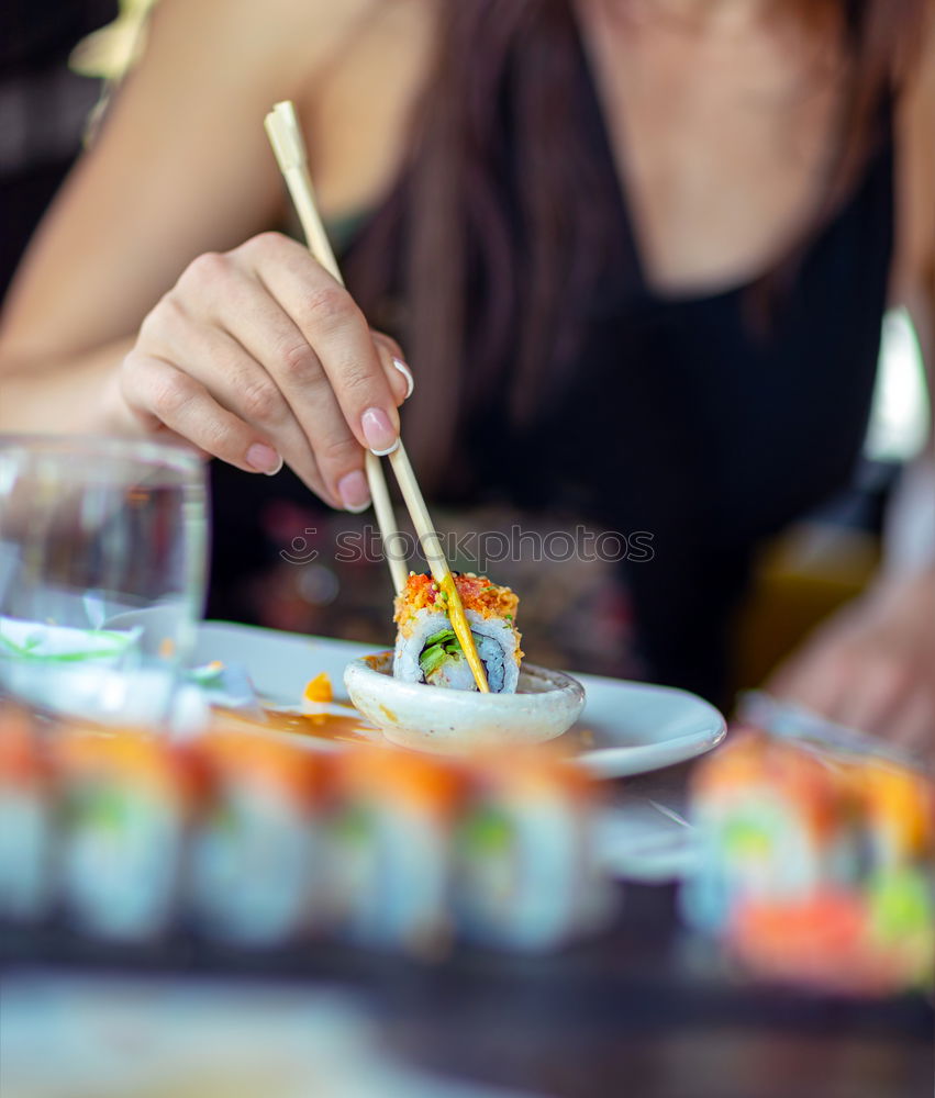 Similar – Crop woman eating sushi