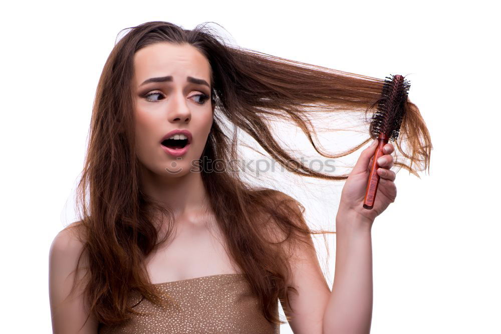 Similar – Portrait of a dark blond, long-haired woman looking into the camera through the hair on her face