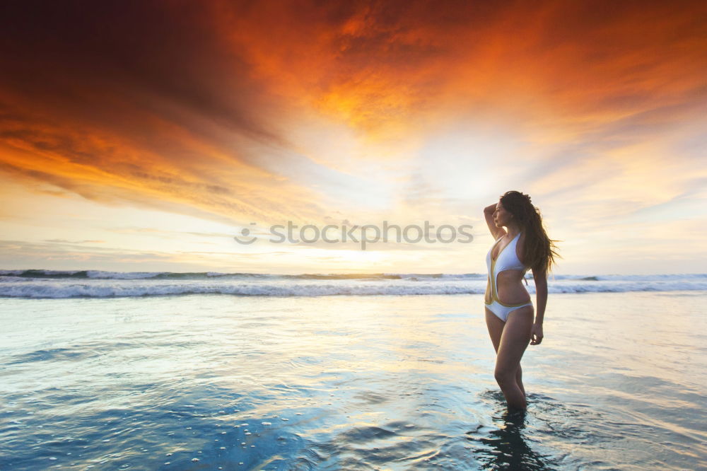 Similar – Frog perspective | woman goes into the sea