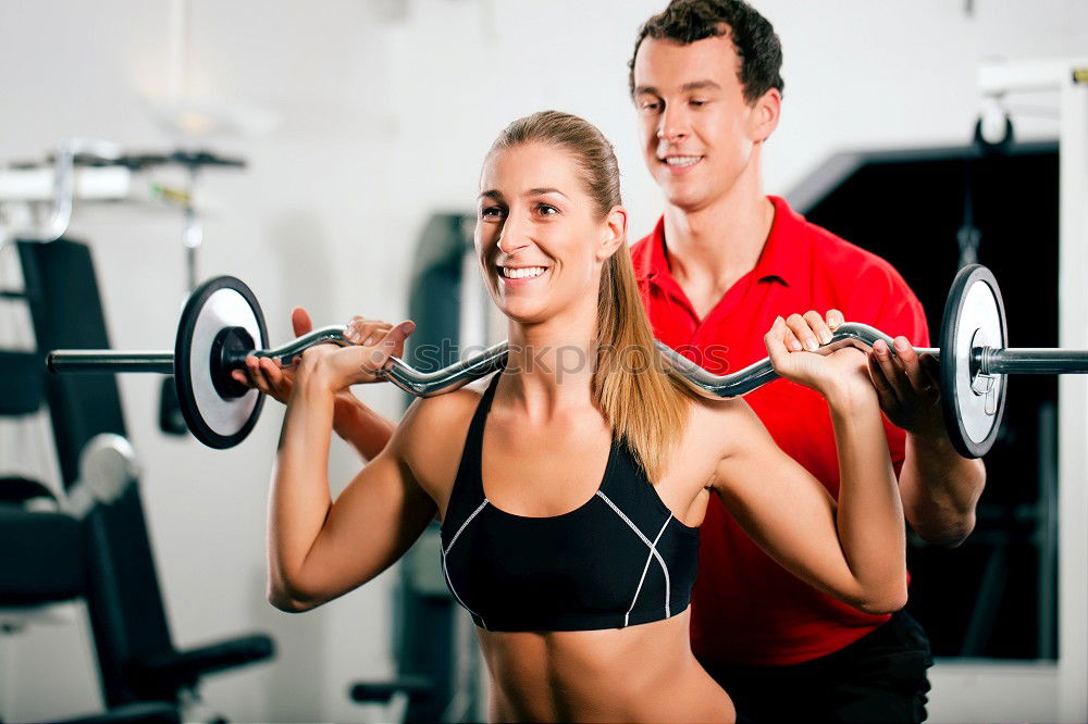 Similar – Female personal trainer helping a young man lift weights