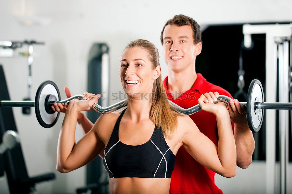 Similar – Female personal trainer helping a young man lift weights