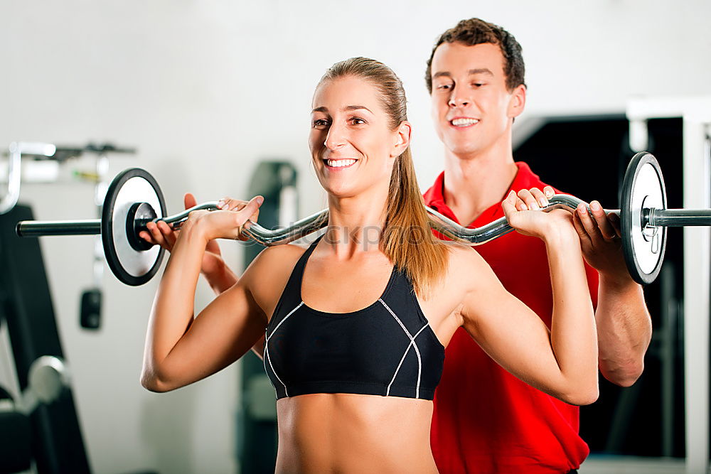 Similar – Man and woman personal trainers in the gym.