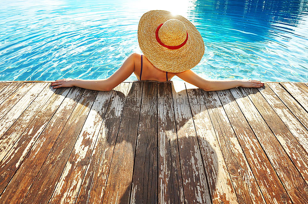 Similar – Image, Stock Photo Black woman lying down in a swimming pool side