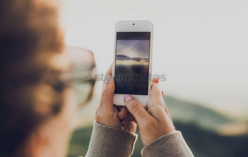 Similar – Image, Stock Photo Young woman is holding smartphone in her hands at the beach