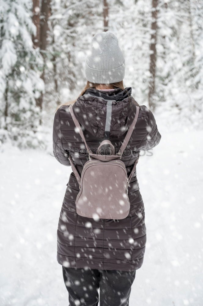 Similar – Woman walking outdoors on sunny snowy day in winter