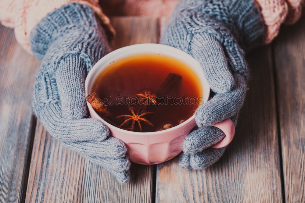 Similar – female hands holding an iron mug with carrot juice