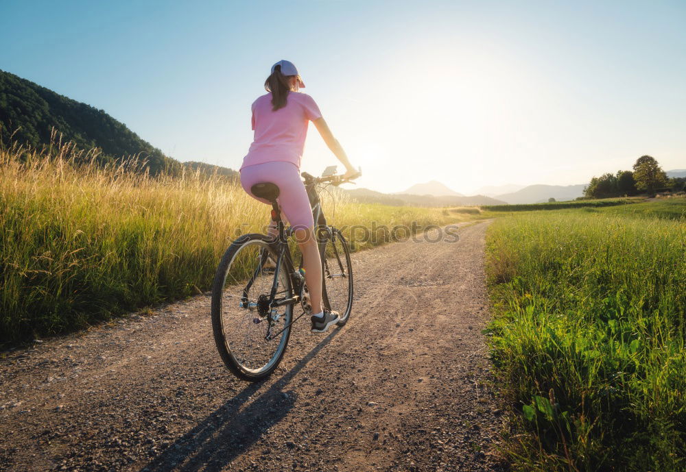 Similar – Image, Stock Photo Woman riding bike looking at camera