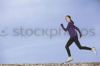 Similar – Young fitness woman runner running on city bridge.