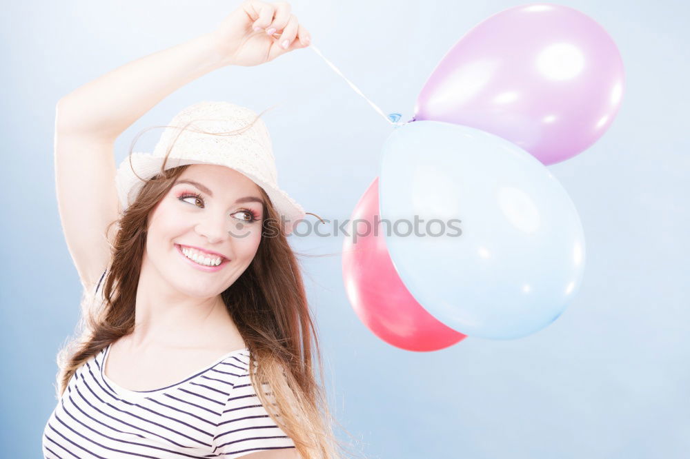 Similar – Young woman with pink hair is licking lollipops