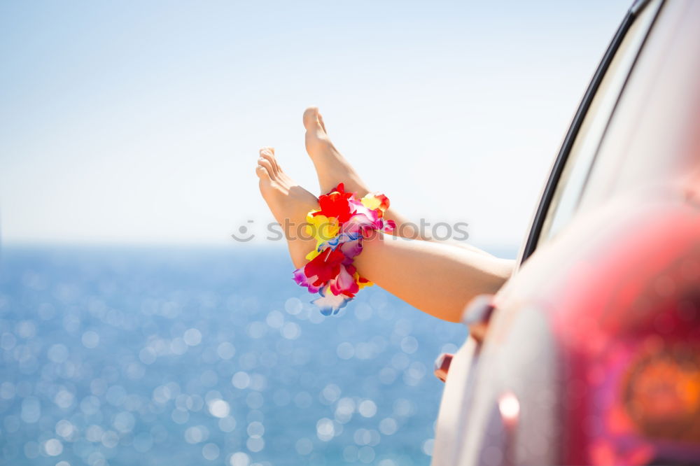 Similar – Unrecognizable man resting feet up sitting on the car