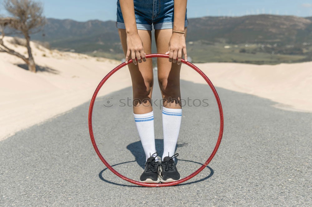 Similar – Teenage girl standing near a wall with balloon and axe