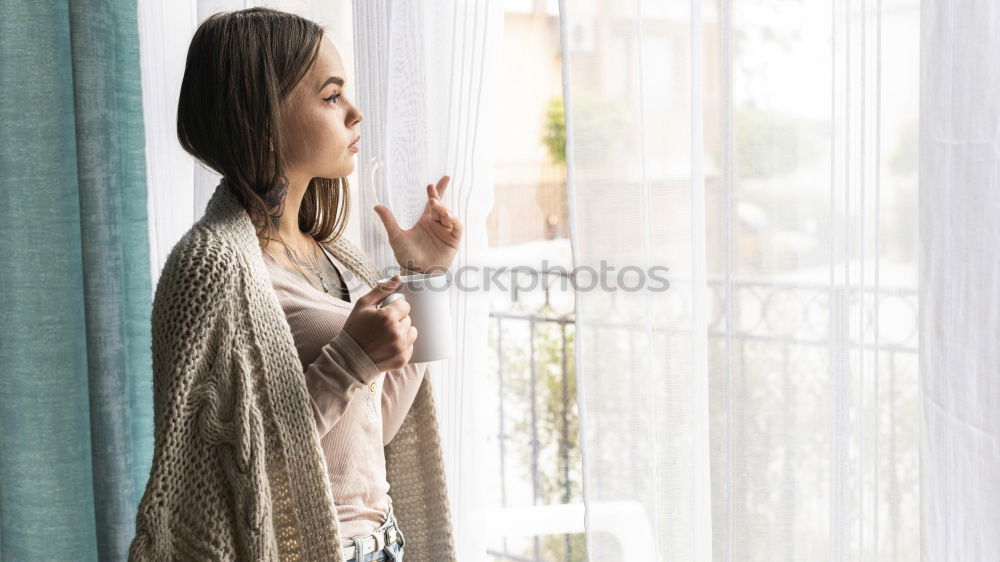 Dreaming girl looking away in window