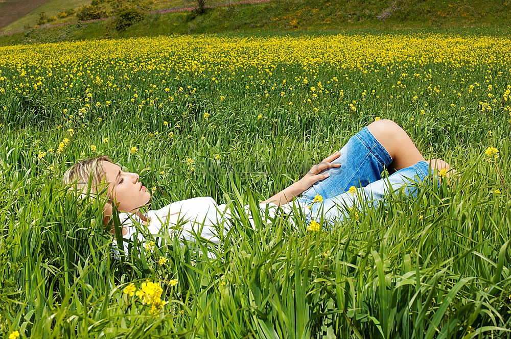 Similar – Jule Young woman with dreads is sitting on a bench in the green.