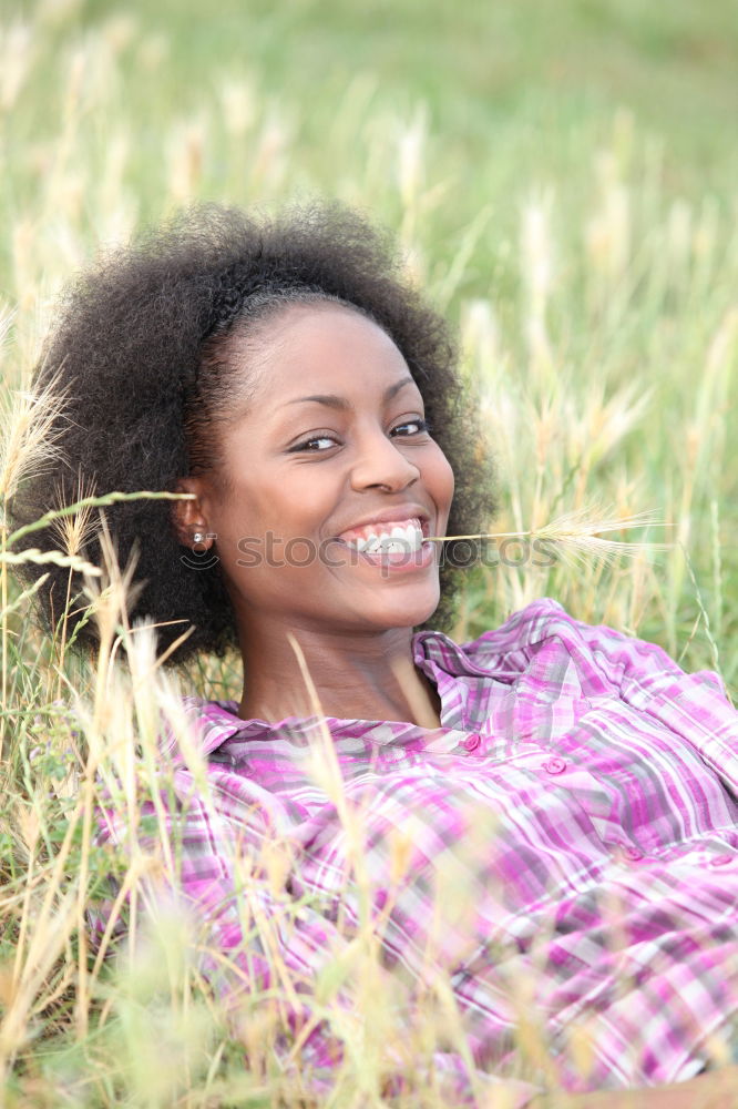 Similar – Young African American woman lying on grass