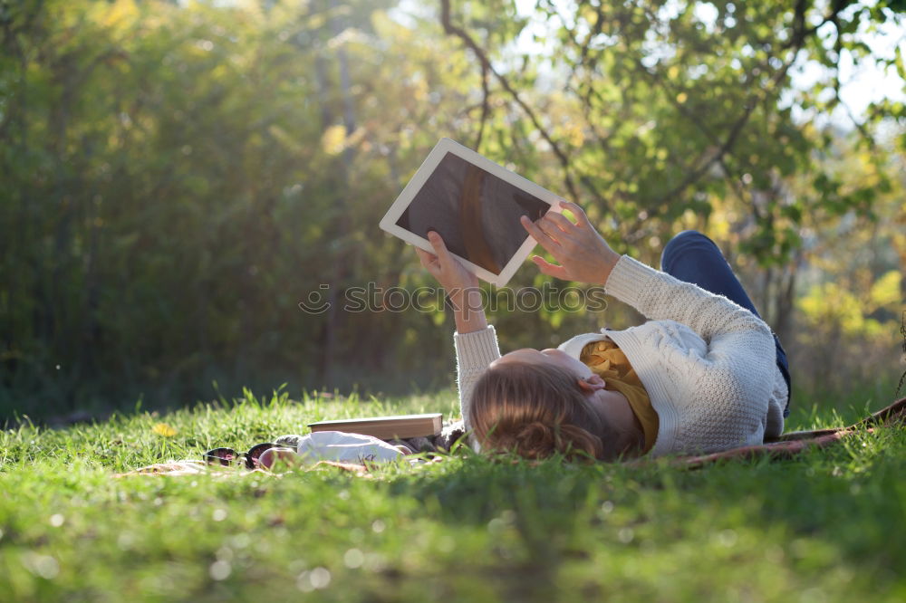 Similar – Image, Stock Photo Girl siting under the tree, reading the book