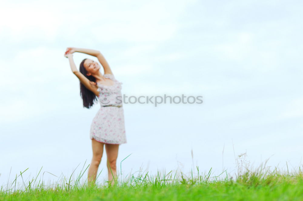 Similar – Young woman with her arms raised to the sky