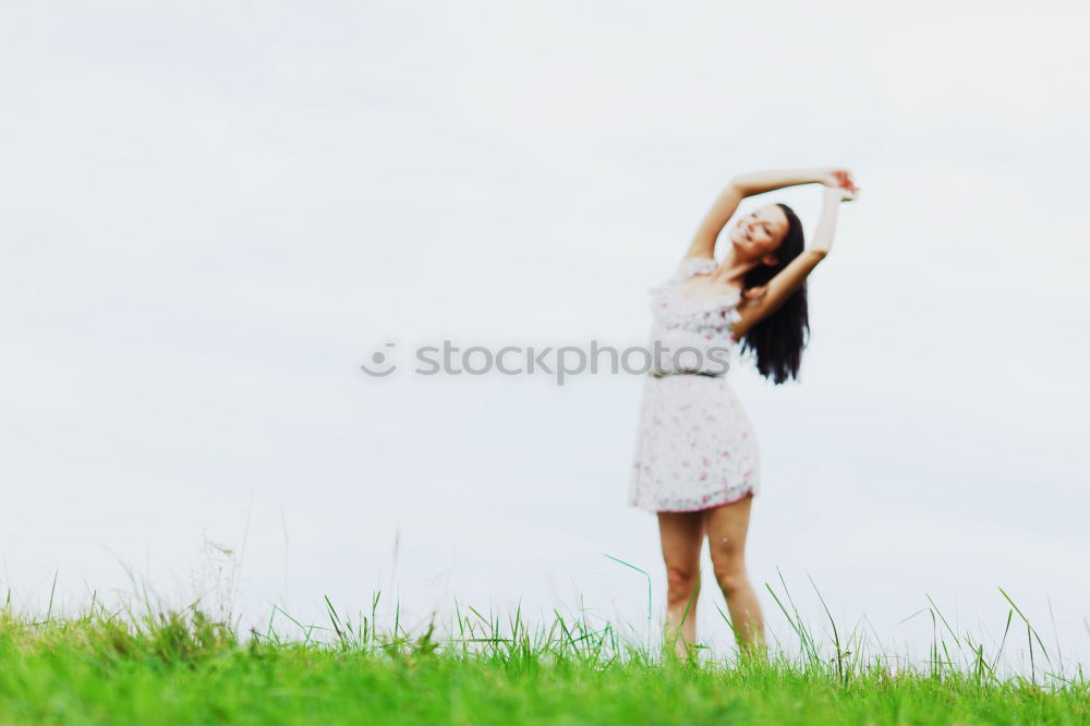 Similar – Young woman with her arms raised to the sky