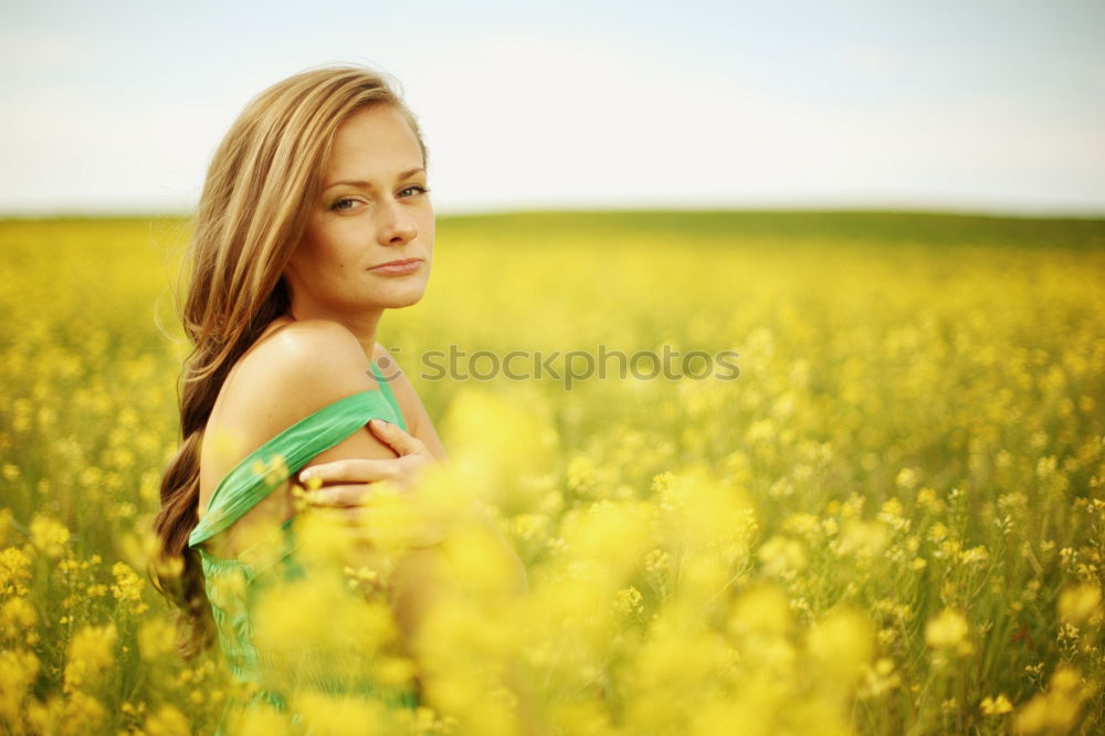 Similar – Image, Stock Photo Thoughtful young woman with bowed head on yellow meadow. Attractive girl with bowed head on a meadow of flowers in yellow to the horizon in the sunshine in spring or summer. Photo of a series.