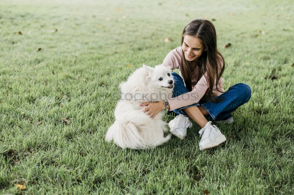 Similar – young woman with her dog at the park. she is kissing the dog. autumn season