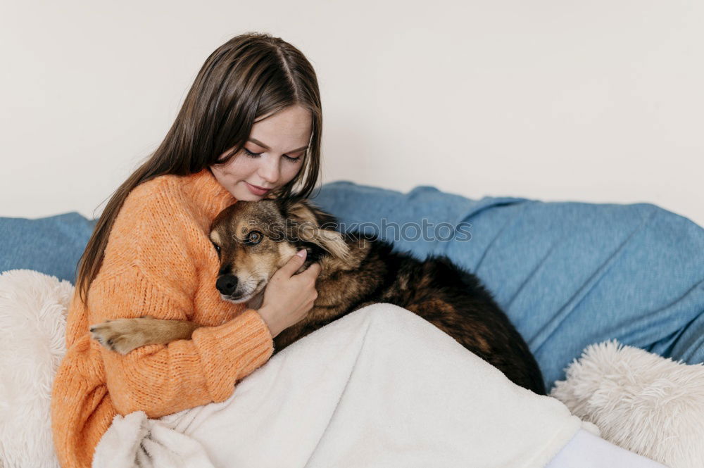 Similar – Foto Bild Junge Frau sitzt mit einem Tablet auf einem kleinen Hund auf einem grauen Sofa