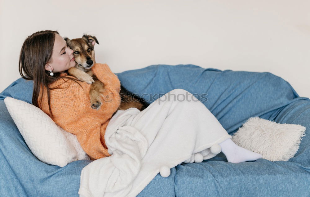 Similar – Foto Bild Junge Frau sitzt mit einem Tablet auf einem kleinen Hund auf einem grauen Sofa