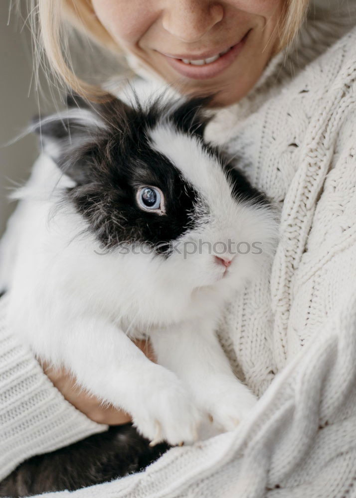 Similar – Girl cuddles with rabbit