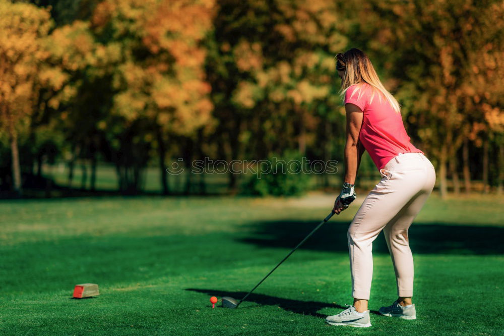 Similar – Female golfer practicing on a driving range