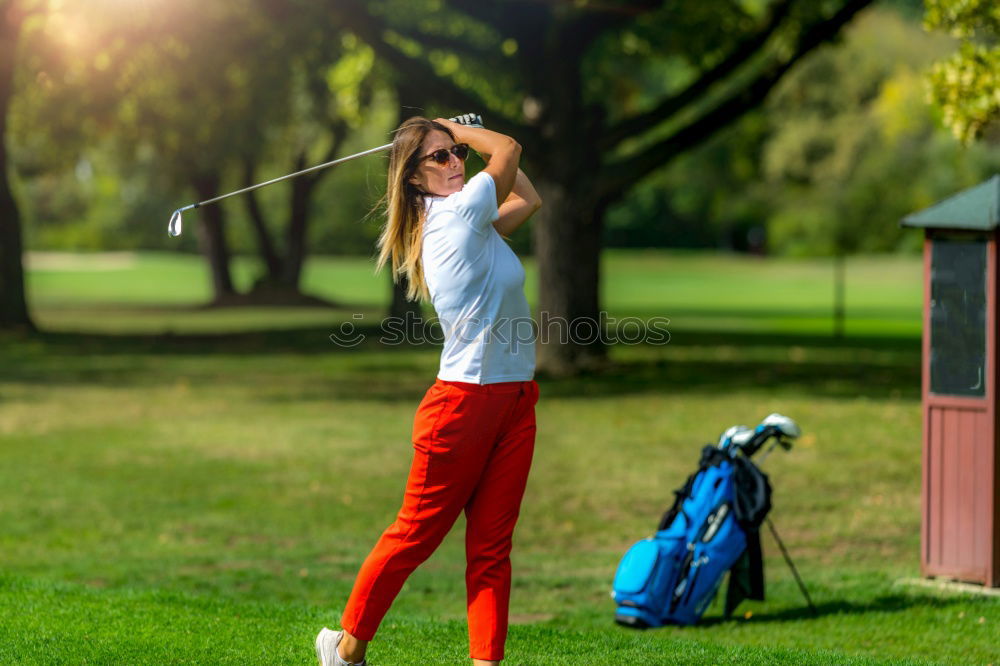 Similar – Female golfer practicing on a driving range